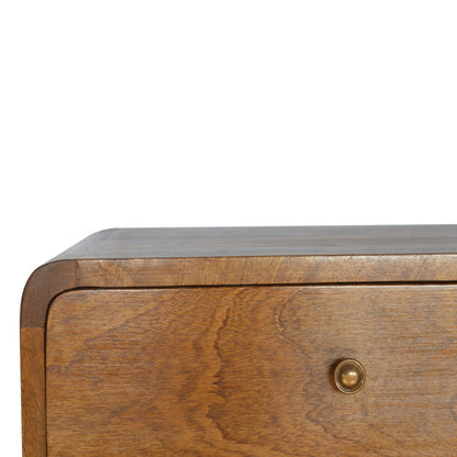 Wooden drawer of a bedside table with a metallic handle on a white background