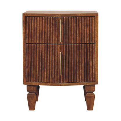 A mid-century modern wooden nightstand with two doors featuring vertical fluted grooves and slim brass handles, supported by turned block legs, shown against a plain white background.