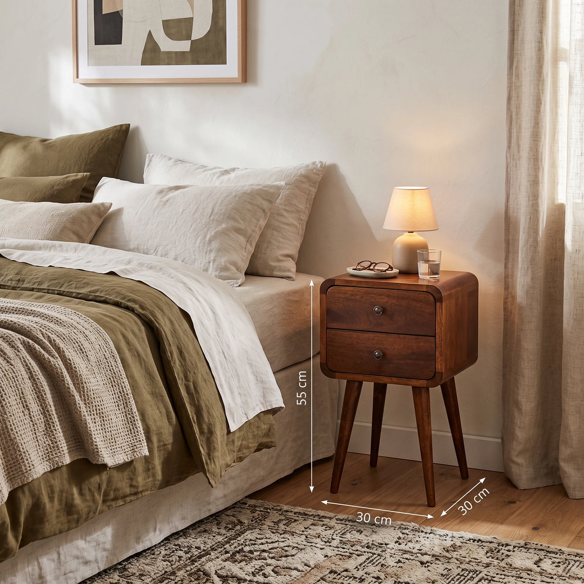 A wooden two-drawer nightstand beside a bed in a styled bedroom, with overlaid dimension lines showing 55 cm height and 30 cm width/depth. No person or animal is present, but the real bedroom environment is visible, so this is Lifestyle rather than Product/Packaging.