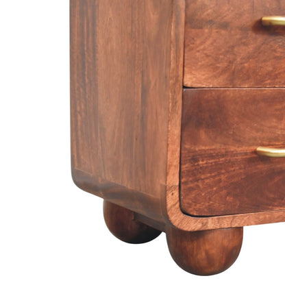 Close-up of a wooden drawers of a chest with gold handles on a white background