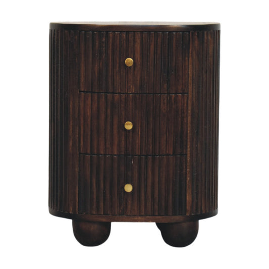 Front view of a solid mango wood curved bedside table in velvet mocha, featuring a vertical fluted texture, three drawers with small brass knobs, and round bun feet.