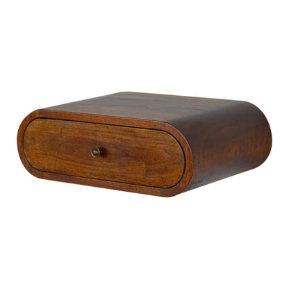 Right up angle view of wall mounted round chestnut bedside table